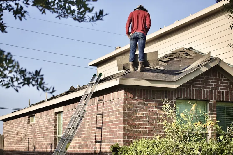 Professional roofer working on a residential roof in Washington Highlands